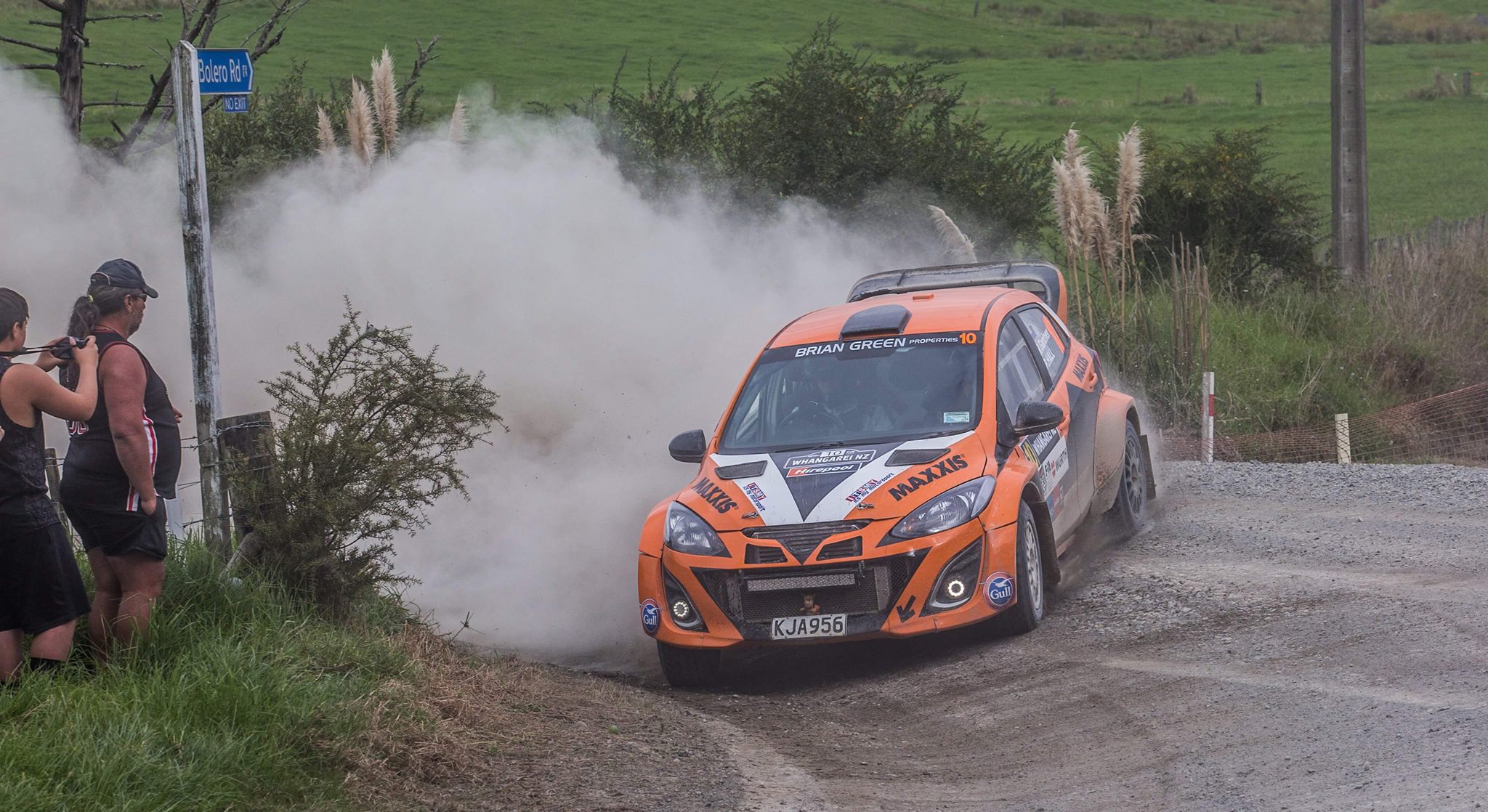 A Mazda AP4 rally car sideways around a corner